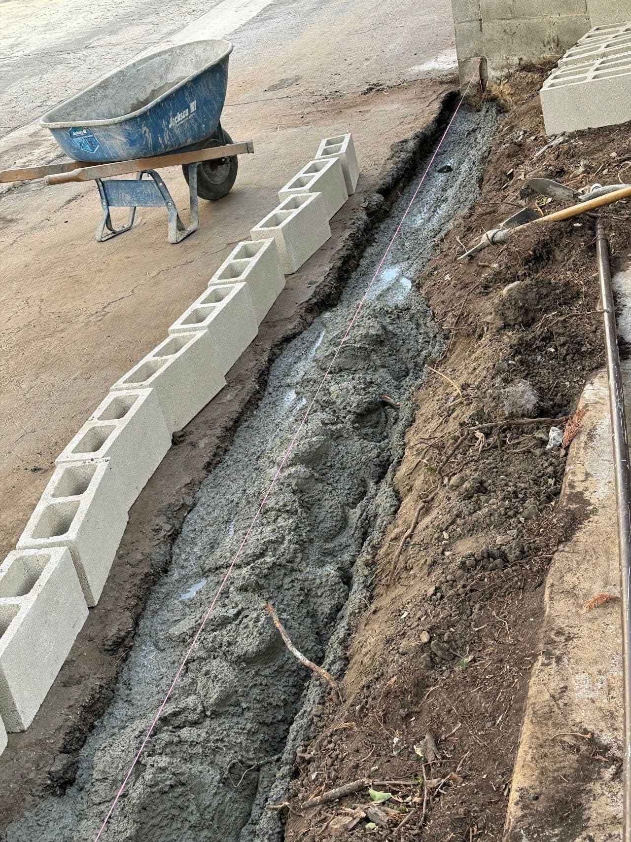 First course of block set on a fresh concrete footing