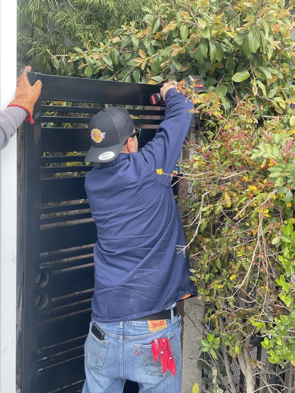 Working on metal fence installation