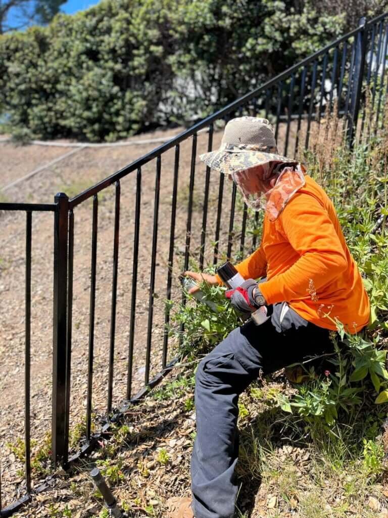 Working on metal fence installation